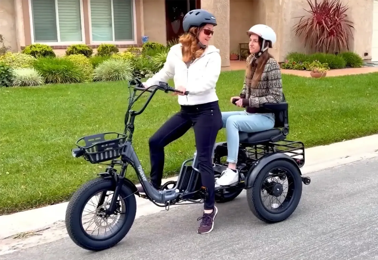 Tiniover Creek Pro electric trike carrying a passenger on a residential street