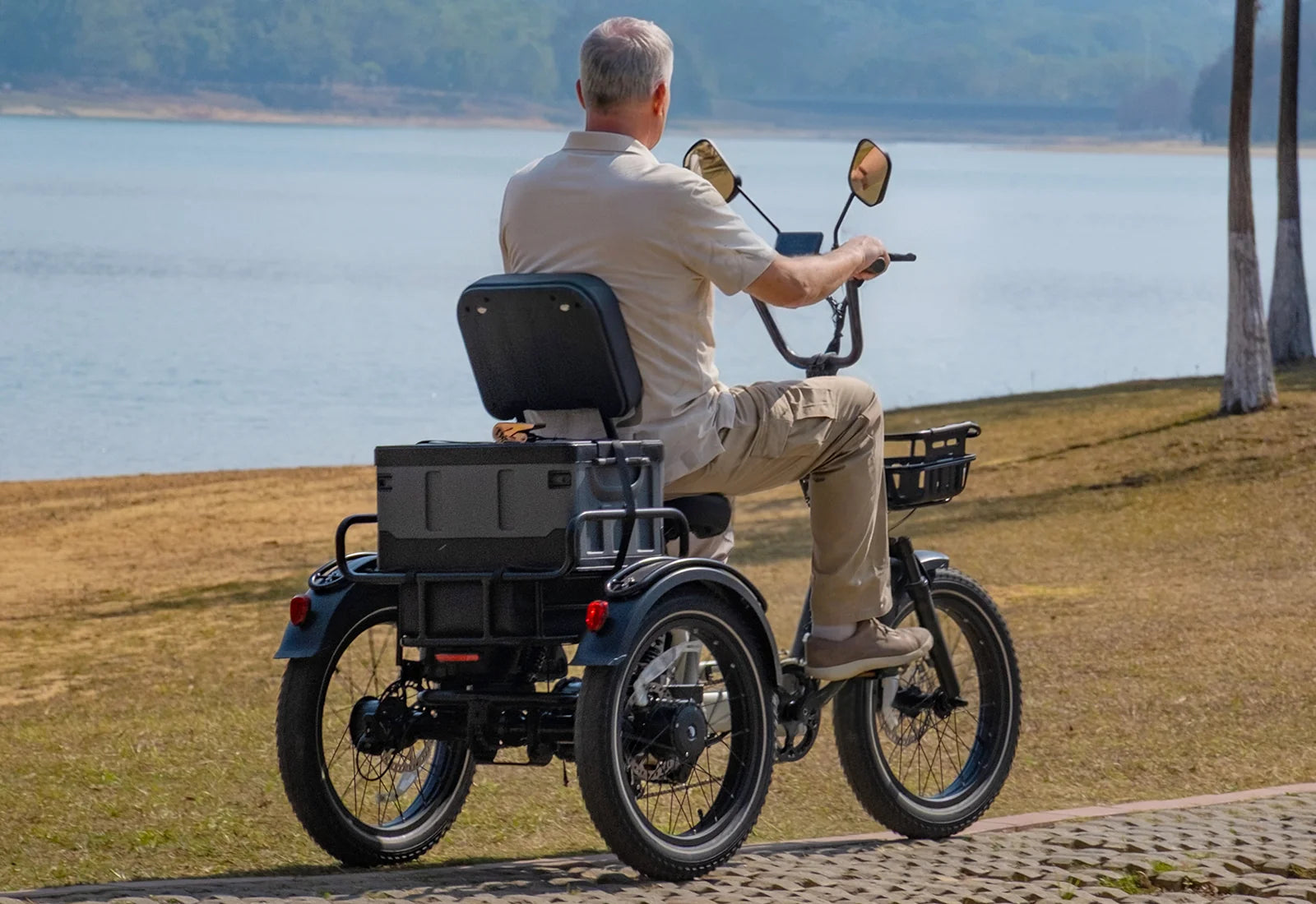 White Tiniover River electric trike viewed from behind with a rear storage box, front basket, and three fat tires