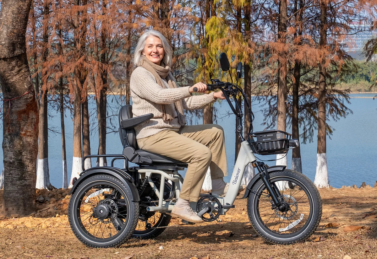 White Tiniover River electric trike with a semi-recumbent backrest and front basket beside a lake