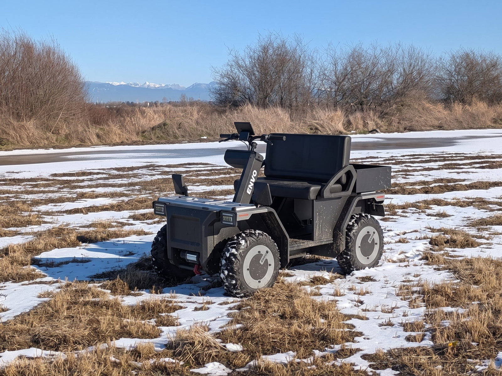 ENVO AT23 electric side-by-side UTV in front three-quarter view with two seats, cargo bed and roof