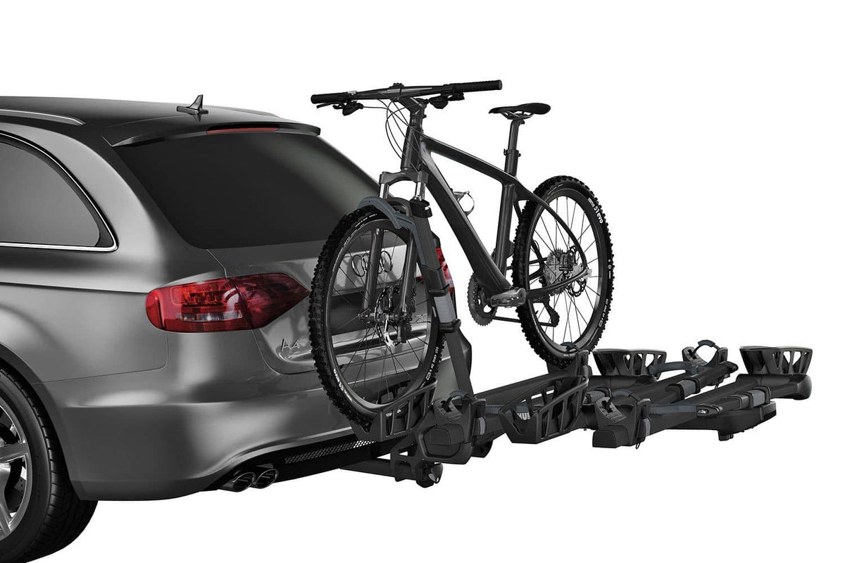 Thule T2 Pro XT add-on hitch attachment close-up — slides directly onto the receiver of the base rack, no separate ball mount needed